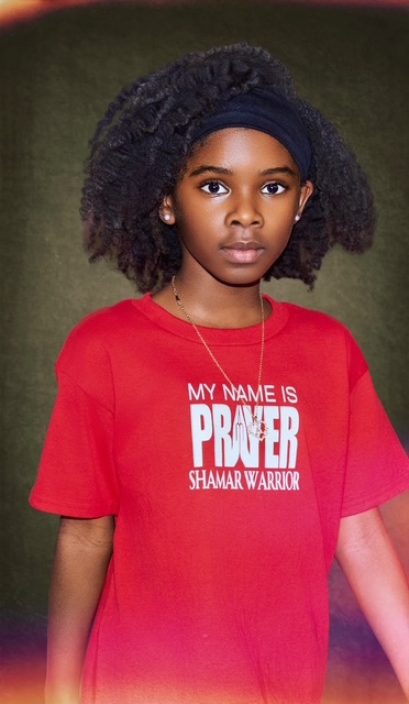A young girl wearing a red My Name Is Prayer Shamar Warrior tee