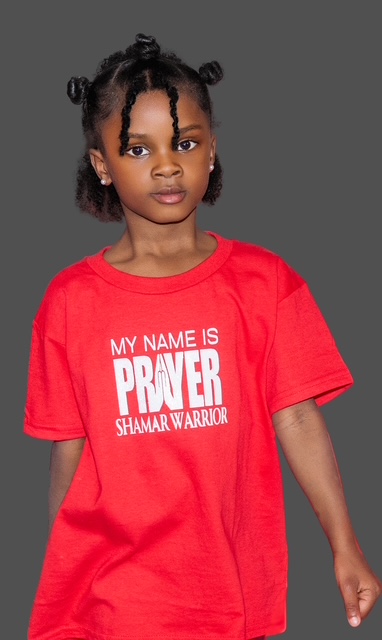 A child wearing a red My Name Is Prayer Shamar Warrior tee
